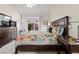 Comfortable main bedroom with floral bedding, ceiling fan, and access to backyard area at 9256 Blue Flax Pl, Las Vegas, NV 89148