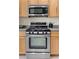 Stainless steel oven and microwave, set in wood cabinets with light countertops at 9256 Blue Flax Pl, Las Vegas, NV 89148