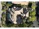 Aerial view of a luxurious home showcasing its elegant architecture, private pool, and meticulously landscaped grounds at 9408 Players Canyon Ct, Las Vegas, NV 89144
