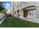 Lush green backyard featuring a covered patio perfect for outdoor entertaining at 9408 Players Canyon Ct, Las Vegas, NV 89144