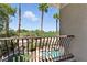 Balcony view of palm trees, green grass, and a swimming pool at 9408 Players Canyon Ct, Las Vegas, NV 89144