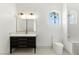 Stylish bathroom boasts a modern vanity with sleek black drawers and a framed mirror at 9408 Players Canyon Ct, Las Vegas, NV 89144