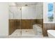The elegant bathroom has a glass enclosed shower with marble accents and a standalone tub at 9408 Players Canyon Ct, Las Vegas, NV 89144