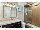 Stylish bathroom featuring a glass shower, marble countertops, and chic floral wallpaper at 9408 Players Canyon Ct, Las Vegas, NV 89144