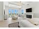The large bedroom boasts double-door yard access, a fireplace, and an elegant tray ceiling with a chandelier at 9408 Players Canyon Ct, Las Vegas, NV 89144