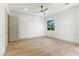 Bright bedroom featuring light wood floors and a view to a window at 9408 Players Canyon Ct, Las Vegas, NV 89144