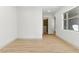Neutral bedroom featuring light wood floors, walk-in closet and white walls at 9408 Players Canyon Ct, Las Vegas, NV 89144