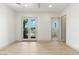 A well-lit bedroom includes light wood floors and glass paneled doors leading to a balcony at 9408 Players Canyon Ct, Las Vegas, NV 89144