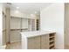 Walk-in closet with custom shelving, drawers, and a center island with a marble countertop for organization at 9408 Players Canyon Ct, Las Vegas, NV 89144