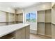 Spacious walk-in closet with custom built-in shelves, drawers, and window seat, providing ample storage at 9408 Players Canyon Ct, Las Vegas, NV 89144