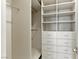 Walk-in closet with built-in shelving and drawers for organized storage at 9408 Players Canyon Ct, Las Vegas, NV 89144