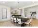 An elegant dining room features modern lighting and an open layout at 9408 Players Canyon Ct, Las Vegas, NV 89144