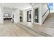 Bright and airy foyer with hardwood floors, a staircase, and modern finishes at 9408 Players Canyon Ct, Las Vegas, NV 89144