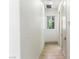 Clean hallway featuring neutral walls and trim, modern recessed lighting, and light hardwood-style flooring at 9408 Players Canyon Ct, Las Vegas, NV 89144