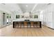 Spacious kitchen features an island with seating, modern lighting, and stainless appliances at 9408 Players Canyon Ct, Las Vegas, NV 89144