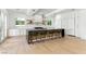 Spacious kitchen features an island with seating, modern lighting, and stainless appliances at 9408 Players Canyon Ct, Las Vegas, NV 89144