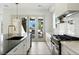 Bright kitchen with granite countertops, stainless steel appliances, and backyard access at 9408 Players Canyon Ct, Las Vegas, NV 89144