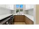 Bright laundry room featuring sleek washer and dryer, ample countertop space, and overhead storage for organization at 9408 Players Canyon Ct, Las Vegas, NV 89144