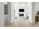Open floor plan living room with fireplace, and white shelving at 9408 Players Canyon Ct, Las Vegas, NV 89144