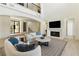 Bright and spacious living room with fireplace and comfortable seating at 9408 Players Canyon Ct, Las Vegas, NV 89144