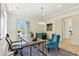 Bright office with wood desk, modern chandelier, and French doors at 9408 Players Canyon Ct, Las Vegas, NV 89144