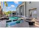 Backyard oasis featuring a swimming pool with spa and covered patio, perfect for outdoor entertaining at 9408 Players Canyon Ct, Las Vegas, NV 89144