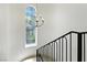 Bright staircase featuring a stained glass window and modern chandelier at 9408 Players Canyon Ct, Las Vegas, NV 89144