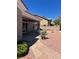 A serene backyard featuring a covered patio, rock landscaping, and a stone walkway at 10036 Keysborough Dr, Las Vegas, NV 89134