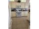 Well-lit kitchen featuring appliances, tile floors and plenty of cabinet space for storage solutions at 10036 Keysborough Dr, Las Vegas, NV 89134