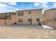 View of the home's rear exterior showing the concrete patio, stucco siding, and spacious yard at 10045 Natchez Trace St, Las Vegas, NV 89178