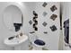 Stylish half-bathroom featuring modern fixtures, decor, and a pedestal sink at 10045 Natchez Trace St, Las Vegas, NV 89178