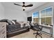 A bedroom that has a desk and office chair, as well as a Queen bed, and a mounted TV at 10045 Natchez Trace St, Las Vegas, NV 89178