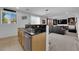 The kitchen overlooks an open concept living area with a bar and seating at 10045 Natchez Trace St, Las Vegas, NV 89178