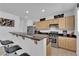 Beautiful kitchen features a breakfast bar, granite counters, stainless steel appliances, and wood cabinets at 10045 Natchez Trace St, Las Vegas, NV 89178
