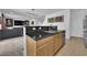 Open kitchen featuring stainless steel sink, black countertop and cabinets, and decorative lighting at 10045 Natchez Trace St, Las Vegas, NV 89178
