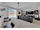 Open-concept living room with sliding glass doors, dark sofa, and unique decor at 10045 Natchez Trace St, Las Vegas, NV 89178