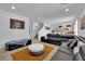 Open-concept living room with large sectional sofa and ample natural light for entertaining at 10045 Natchez Trace St, Las Vegas, NV 89178