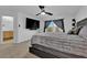 This bedroom features a ceiling fan, carpeted floors, TV, and a large window that brings in natural light at 10045 Natchez Trace St, Las Vegas, NV 89178