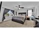 Spacious bedroom with a ceiling fan, a large window, and carpet flooring at 10045 Natchez Trace St, Las Vegas, NV 89178