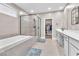 Bathroom with walk in shower, tub, and dual sink vanity at 10301 Fairview Ridge Ct, Las Vegas, NV 89166