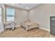Bright bedroom with hardwood floors, ample natural light, and a cozy teddy bear on the bed at 10301 Fairview Ridge Ct, Las Vegas, NV 89166