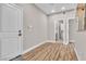 Inviting hallway with wood floors, neutral paint, leading to multiple rooms, including a bathroom at 10301 Fairview Ridge Ct, Las Vegas, NV 89166