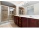 Bathroom featuring double sinks, a glass shower, and tile flooring at 10478 Beallsville St, Las Vegas, NV 89141