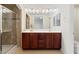 Bathroom featuring a double vanity, a glass-enclosed shower, and tile flooring at 10478 Beallsville St, Las Vegas, NV 89141