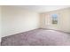Simple, empty bedroom with plush carpeting and natural light at 10478 Beallsville St, Las Vegas, NV 89141