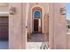 Arched entryway of home with paver flooring and decorative lighting at 10478 Beallsville St, Las Vegas, NV 89141