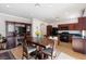 Open concept dining and kitchen area with ample natural light and black appliances at 10478 Beallsville St, Las Vegas, NV 89141