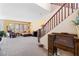 Open living room showcasing a comfortable brown sectional sofa and staircase at 10478 Beallsville St, Las Vegas, NV 89141