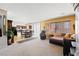 Open-concept living room with kitchen and dining area and a comfortable brown sectional sofa at 10478 Beallsville St, Las Vegas, NV 89141
