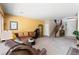 Spacious living room with yellow walls, a large window, and a brown sectional sofa at 10478 Beallsville St, Las Vegas, NV 89141